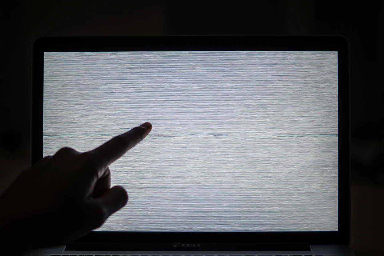 A photo of a MacBook with faint vertical lines across the display.